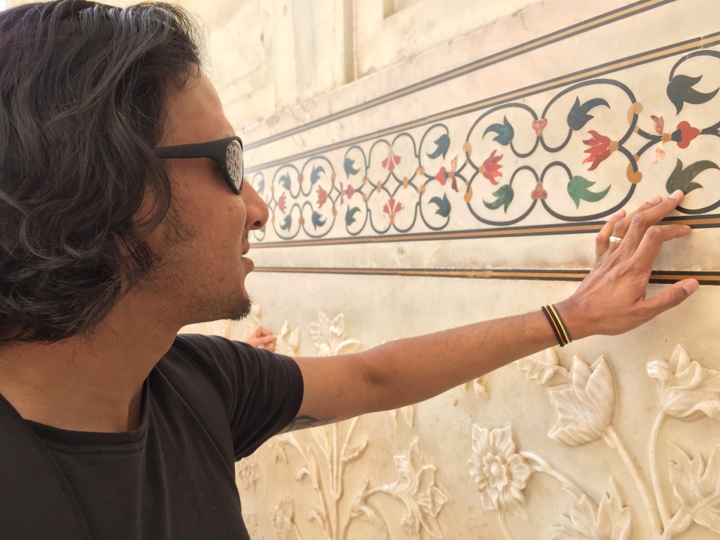 Rupak examines the inlaid precious stones at the entrance of the Taj Mahal